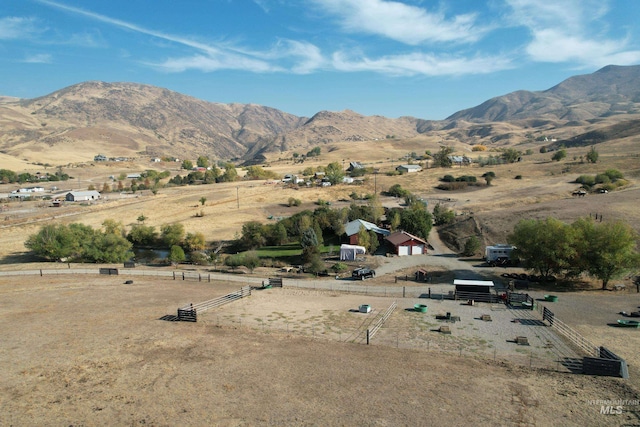 view of mountain backdrop with rural landscape