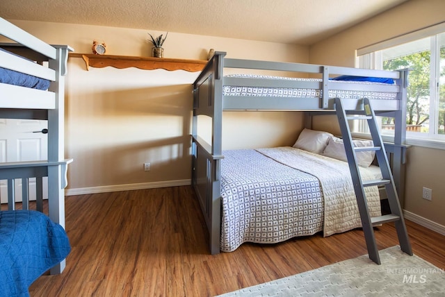 8600 W Brookside Ln, Boise, ID 83714 - bedroom with a textured ceiling, wood finished floors, and baseboards