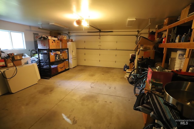 810 Pine St, Filer, ID 83328 - garage featuring white fridge with ice dispenser and a garage door opener