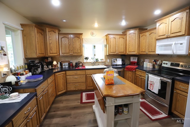 810 Pine St, Filer, ID 83328 - kitchen featuring white microwave, stainless steel electric stove, tasteful backsplash, dark wood-style floors, and wooden counters