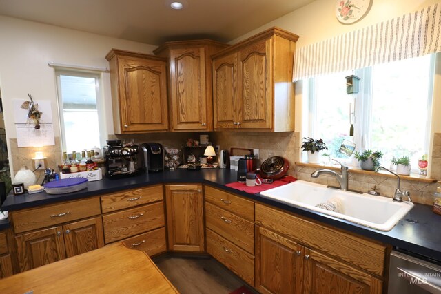 810 Pine St, Filer, ID 83328 - kitchen featuring a sink, dishwasher, decorative backsplash, brown cabinets, and dark countertops
