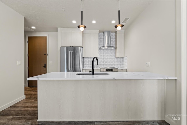 3928 E Haystack St Unit 2-208, Boise, ID 83716 - kitchen featuring freestanding refrigerator, wall chimney exhaust hood, recessed lighting, dark wood-style flooring, and decorative backsplash
