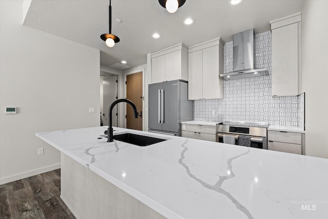 3928 E Haystack St Unit 2-208, Boise, ID 83716 - kitchen with appliances with stainless steel finishes, wall chimney range hood, a sink, dark wood finished floors, and white cabinetry