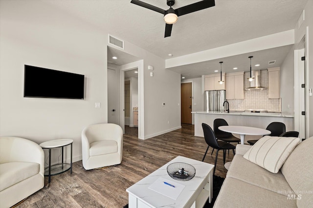 3928 E Haystack St Unit 2-208, Boise, ID 83716 - living room featuring dark wood-type flooring, baseboards, a ceiling fan, recessed lighting, and a textured ceiling