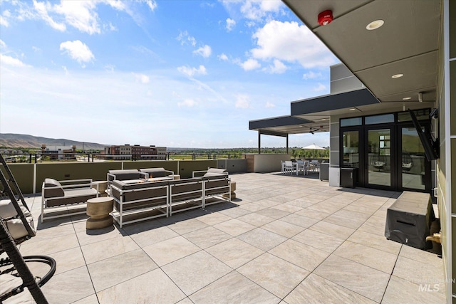 3928 E Haystack St Unit 2-208, Boise, ID 83716 - view of patio / terrace with french doors, an outdoor living space, and a mountain view