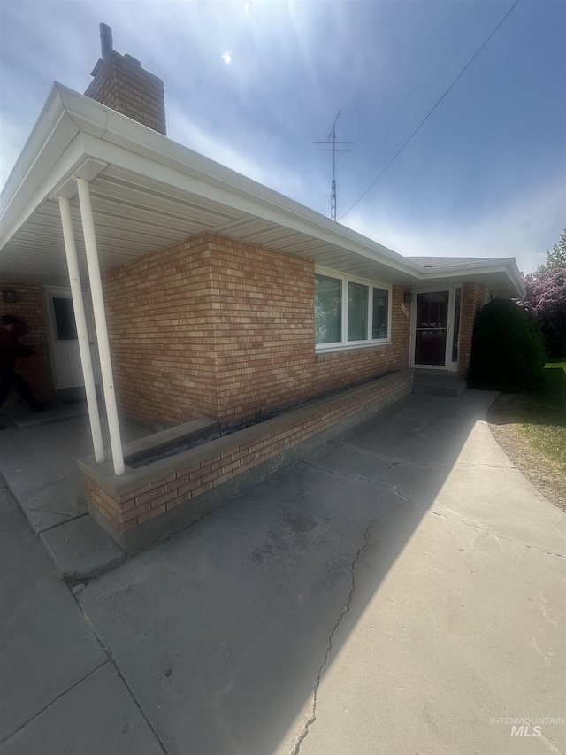 1403 W 16th St, Burley, ID 83318 - view of home's exterior featuring a chimney and brick siding
