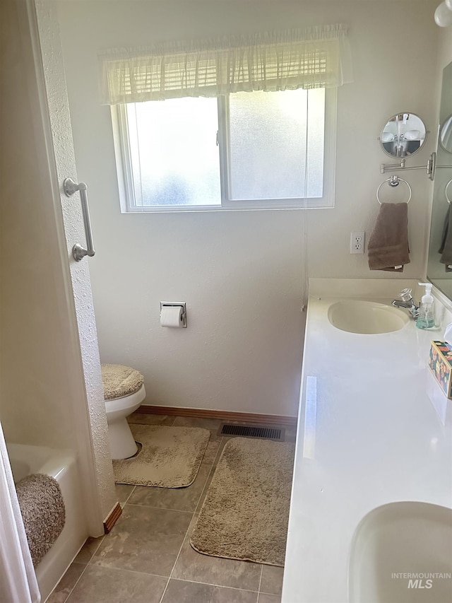 1403 W 16th St, Burley, ID 83318 - bathroom with toilet, vanity, and tile patterned floors