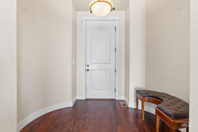 entryway featuring baseboards, dark wood-style flooring, and visible vents