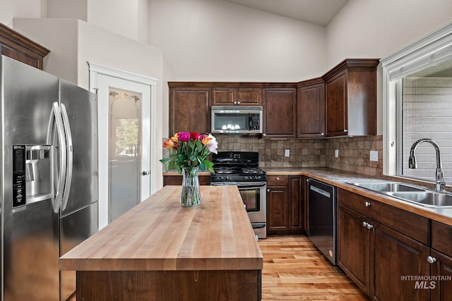 3401 S Murlo Way, Meridian, ID 83642 - kitchen with stainless steel appliances, wood counters, a sink, decorative backsplash, and dark brown cabinets