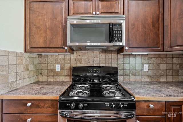 3401 S Murlo Way, Meridian, ID 83642 - kitchen with range with gas cooktop, stainless steel microwave, tasteful backsplash, and dark countertops