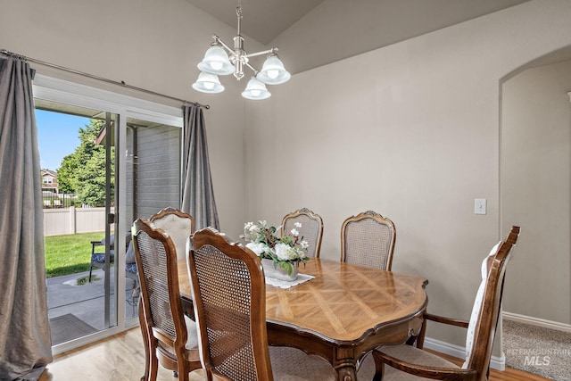 3401 S Murlo Way, Meridian, ID 83642 - dining space with vaulted ceiling, arched walkways, a chandelier, light wood-style flooring, and baseboards