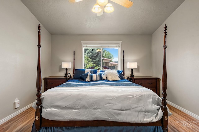 3401 S Murlo Way, Meridian, ID 83642 - bedroom featuring baseboards, wood finished floors, a textured ceiling, and ceiling fan