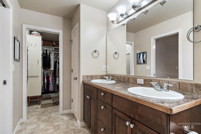 3401 S Murlo Way, Meridian, ID 83642 - bathroom featuring double vanity, a spacious closet, and baseboards