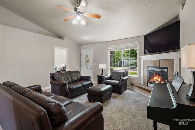 3401 S Murlo Way, Meridian, ID 83642 - living room featuring a tiled fireplace, carpet, a ceiling fan, vaulted ceiling, and baseboards