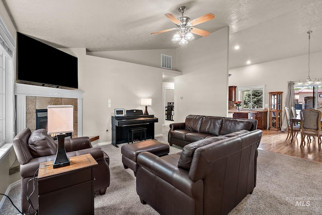 3401 S Murlo Way, Meridian, ID 83642 - living room with carpet floors, ceiling fan, a fireplace, baseboards, and high vaulted ceiling