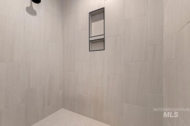 bathroom with a tile shower