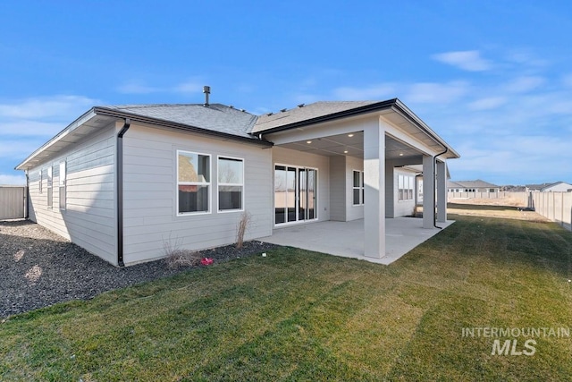 back of property featuring a yard and a patio