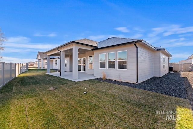 back of house featuring a patio area and a yard