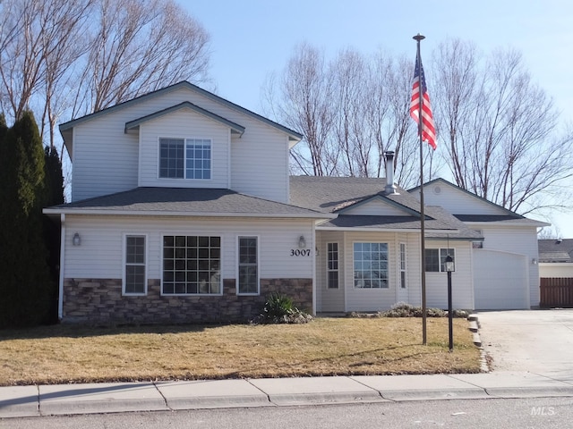 view of front facade with driveway, stone siding, a garage, and a front lawn