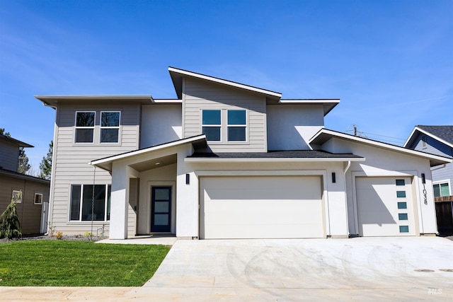 1038 E Fleetwood Ct, Boise, ID 83706 - view of front of property featuring stucco siding, a front lawn, driveway, and a garage