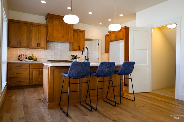 1038 E Fleetwood Ct, Boise, ID 83706 - kitchen with brown cabinets, decorative backsplash, light wood-style floors, and light countertops