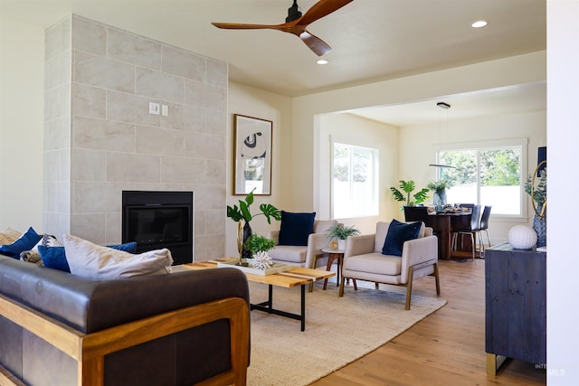 1038 E Fleetwood Ct, Boise, ID 83706 - living room featuring a tile fireplace, ceiling fan, light wood-style floors, and recessed lighting