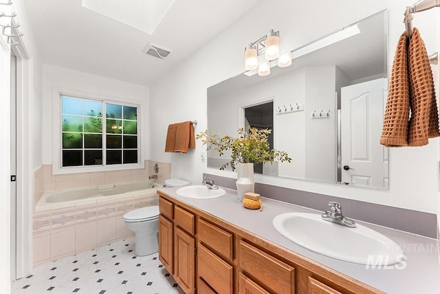 1545 N Ellington Way, Eagle, ID 83616 - bathroom with toilet, a garden tub, double vanity, and a skylight