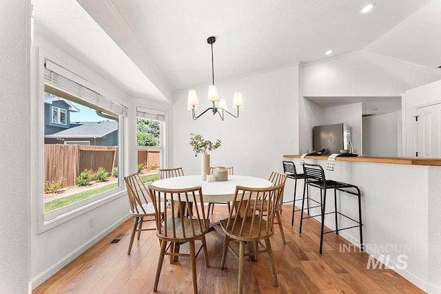 1545 N Ellington Way, Eagle, ID 83616 - dining space with vaulted ceiling, a chandelier, light wood-type flooring, and baseboards