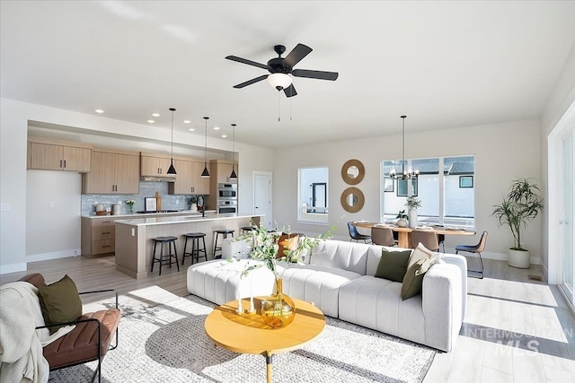 6200 S Binky Ave, Meridian, ID 83642 - living room featuring a chandelier, baseboards, a ceiling fan, recessed lighting, and light wood finished floors
