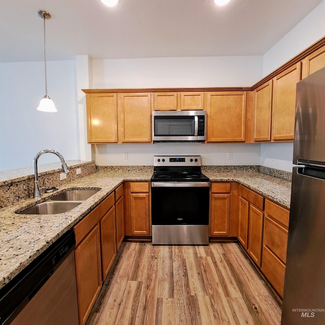 11233 W Gabrielle Dr, Boise, ID 83713 - kitchen featuring stainless steel appliances, a sink, light wood-style flooring, and light stone countertops