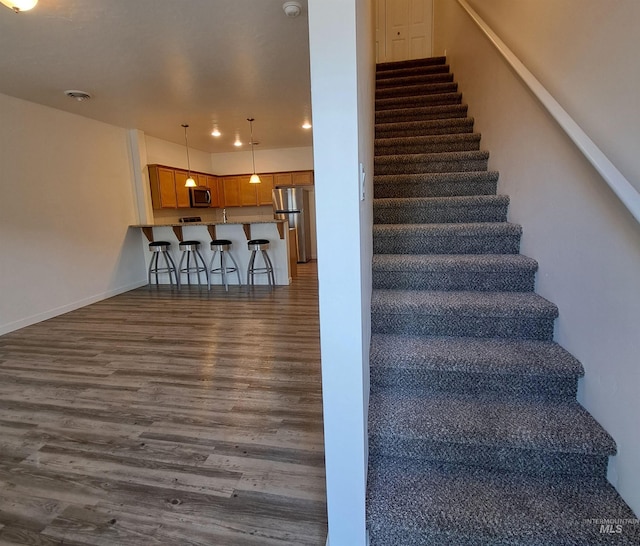 11233 W Gabrielle Dr, Boise, ID 83713 - stairway with wood finished floors, baseboards, and recessed lighting