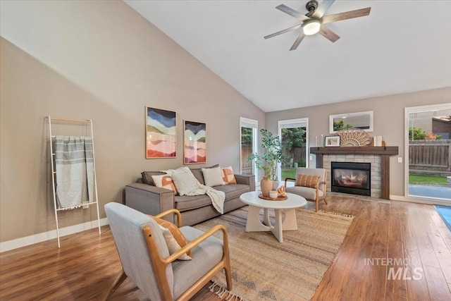 11909 W Patrina Dr, Boise, ID 83713 - living area featuring wood finished floors, high vaulted ceiling, a fireplace, ceiling fan, and baseboards