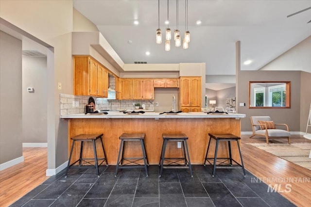 11909 W Patrina Dr, Boise, ID 83713 - kitchen featuring a peninsula, light countertops, tasteful backsplash, and baseboards