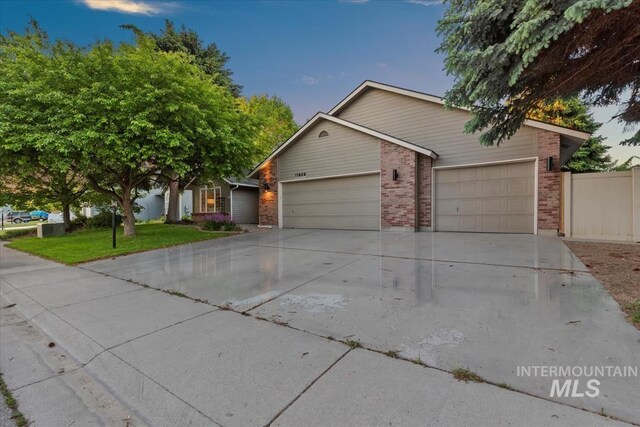 11909 W Patrina Dr, Boise, ID 83713 - single story home featuring an attached garage, brick siding, and driveway