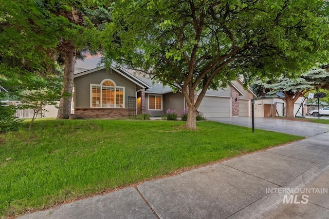 11909 W Patrina Dr, Boise, ID 83713 - view of front facade with brick siding, concrete driveway, a front yard, and an attached garage