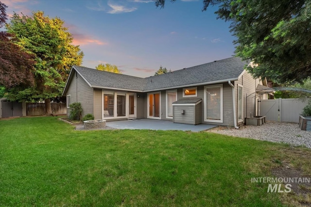 11909 W Patrina Dr, Boise, ID 83713 - rear view of property with a gate, a patio, an outdoor fire pit, and a shingled roof