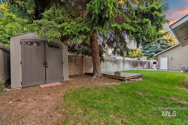 11909 W Patrina Dr, Boise, ID 83713 - yard at dusk with a wooden deck and central air condition unit