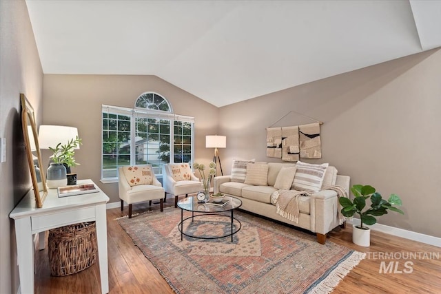 11909 W Patrina Dr, Boise, ID 83713 - living room featuring vaulted ceiling, wood finished floors, and baseboards