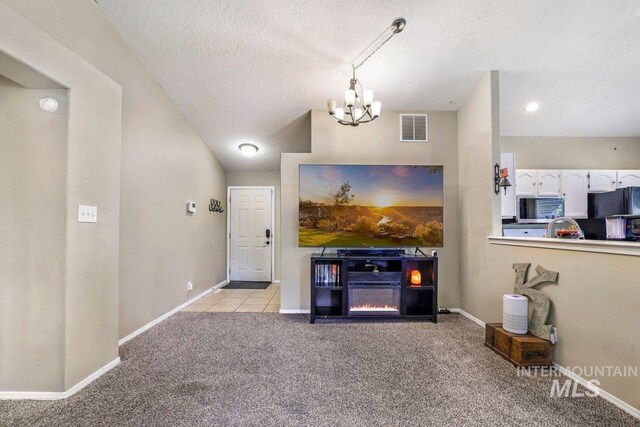 914 Aspenwood Ln, Twin Falls, ID 83301 - living room with a chandelier, light carpet, a textured ceiling, and baseboards
