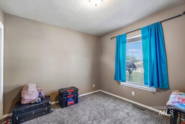 914 Aspenwood Ln, Twin Falls, ID 83301 - unfurnished bedroom with a textured ceiling, baseboards, and carpet flooring