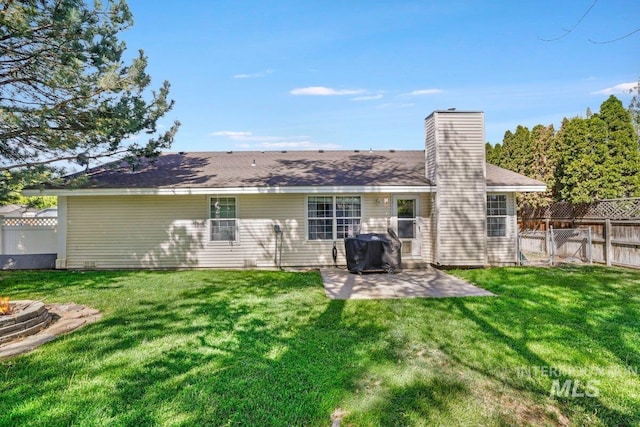 914 Aspenwood Ln, Twin Falls, ID 83301 - rear view of property with a patio, a chimney, a fire pit, and a gate