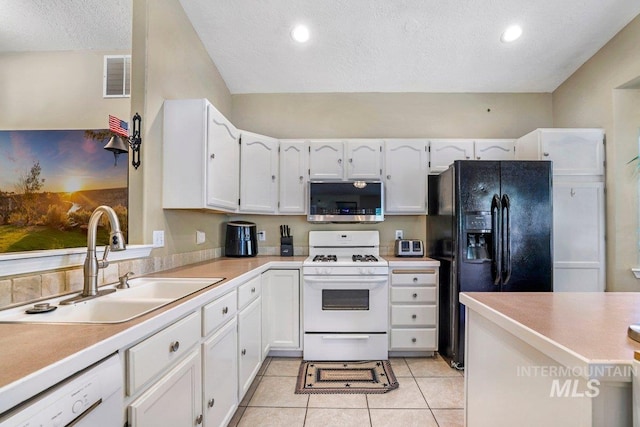 914 Aspenwood Ln, Twin Falls, ID 83301 - kitchen with stainless steel microwave, gas range gas stove, black fridge with ice dispenser, a sink, and a textured ceiling