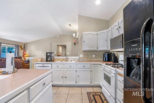 914 Aspenwood Ln, Twin Falls, ID 83301 - kitchen with white appliances, lofted ceiling, a sink, light countertops, and white cabinetry