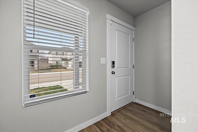 entryway featuring dark wood-style flooring and baseboards