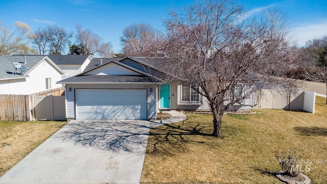 single story home featuring a garage, concrete driveway, a front lawn, and fence