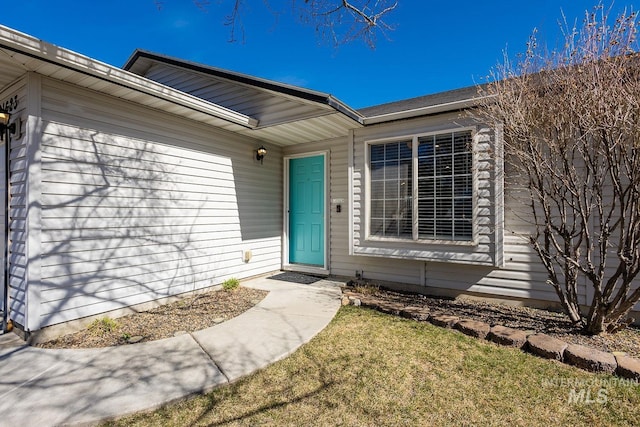 entrance to property with a yard