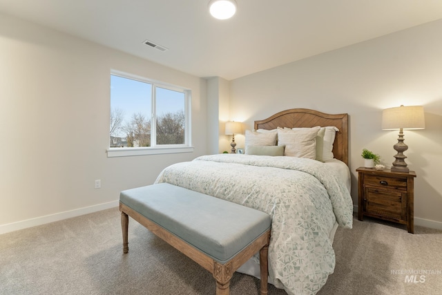 carpeted bedroom with baseboards and visible vents