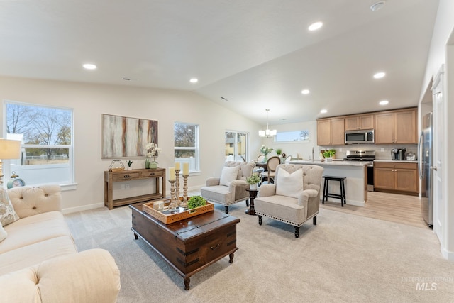 living room with an inviting chandelier, light carpet, vaulted ceiling, and recessed lighting