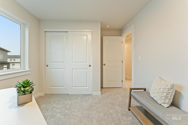 living area featuring visible vents, carpet, and a wealth of natural light