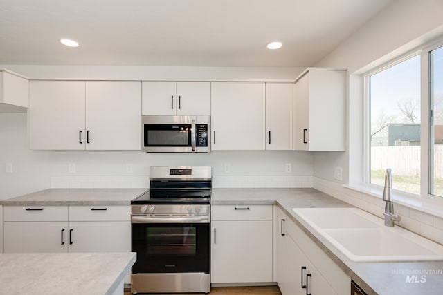 kitchen with white cabinetry, appliances with stainless steel finishes, and sink